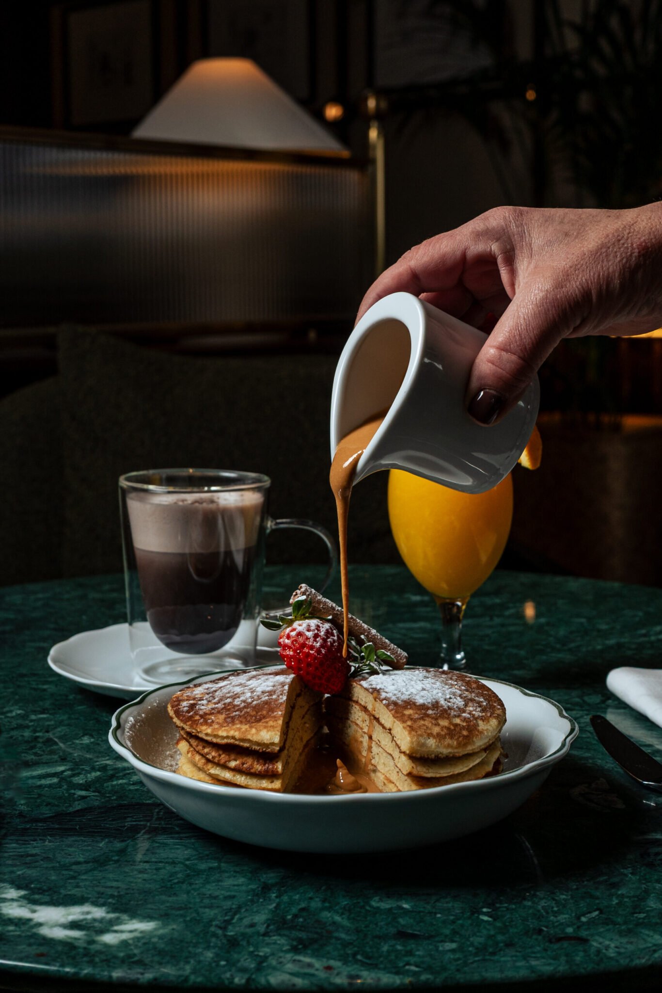 F&B product photography of Vince Miklos, if a stack of pancakes being poured over chocolate sauce