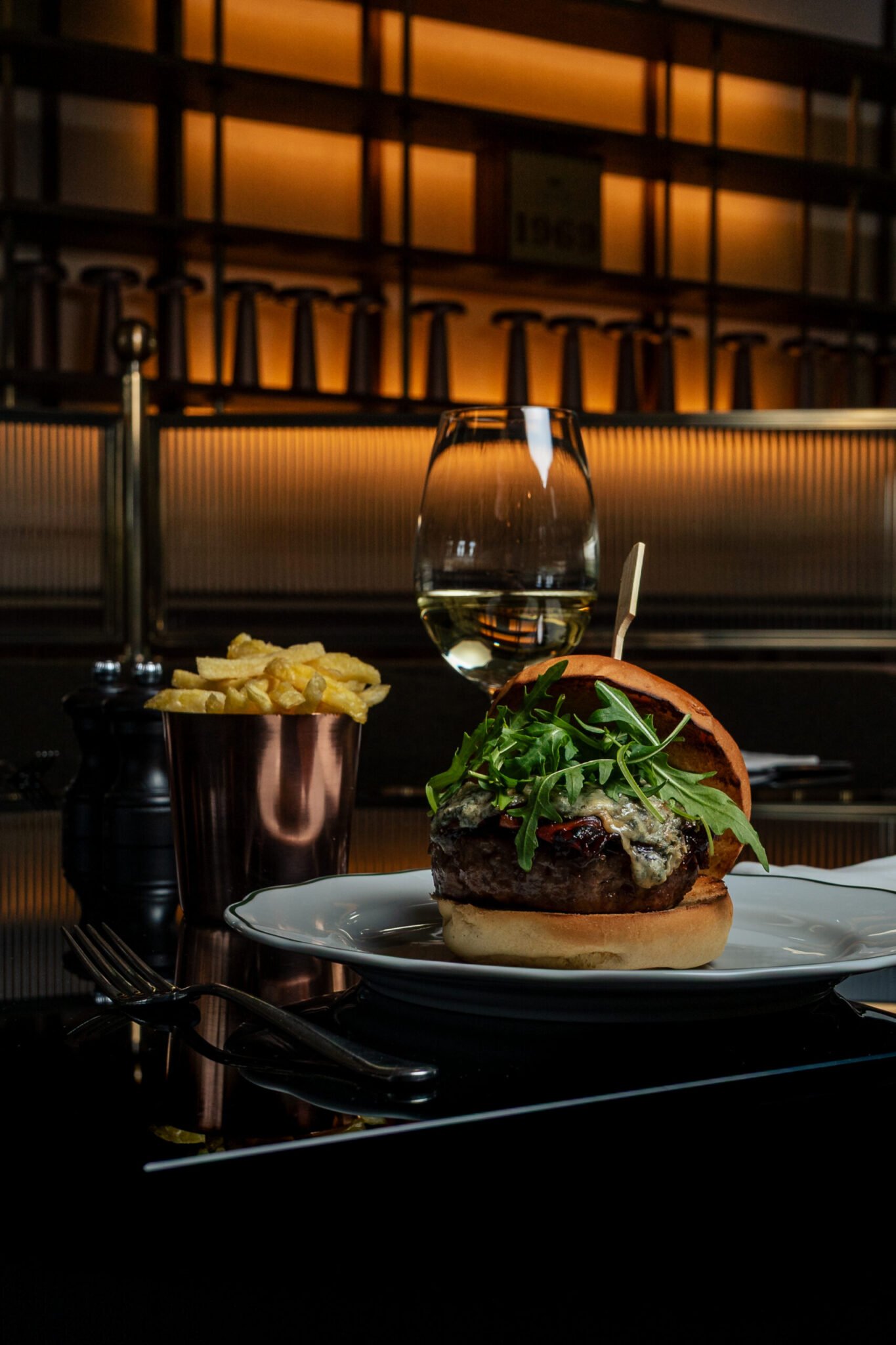 F&B product photography of Vince Miklos, hamburger presented with french fries and a glass of wine